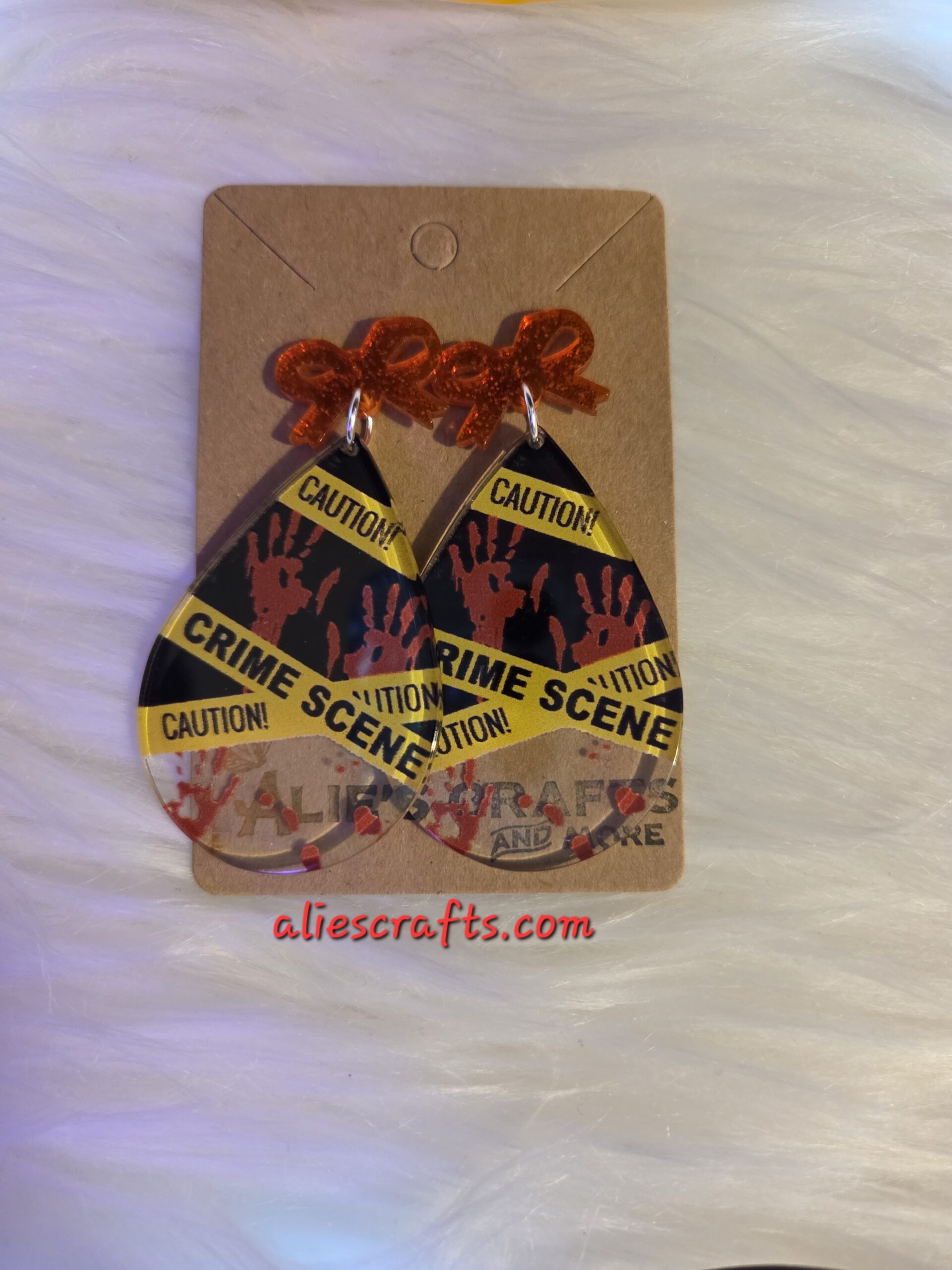 Crime scene earrings with red bows